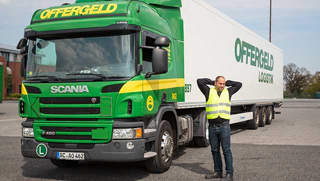 Fahrer streckt sich neben Lkw